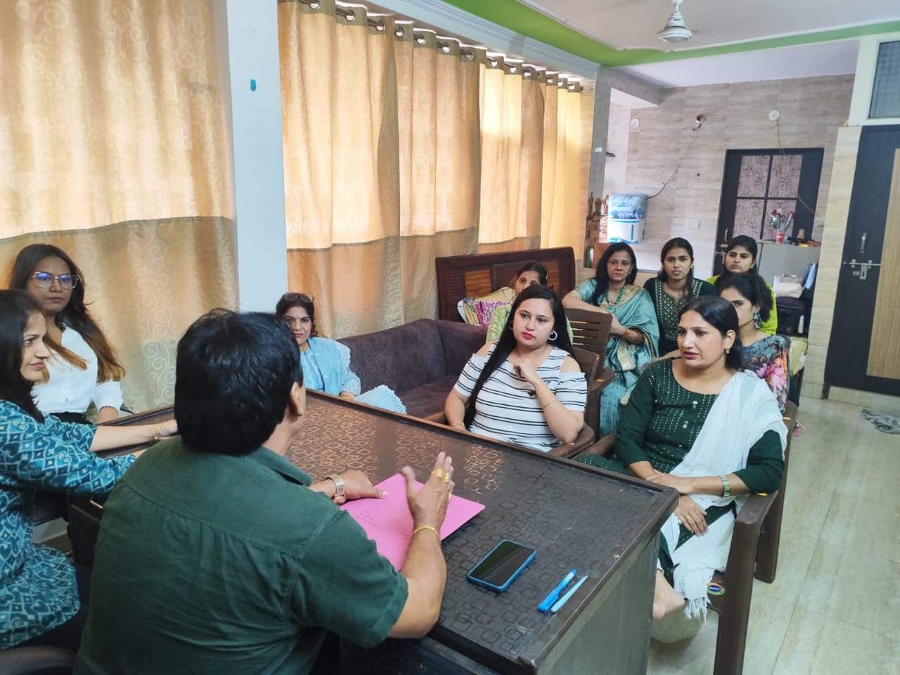 Children in a classroom receiving supplies.
